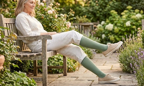 Woman walking confidently outdoors wearing Nimble Ease bamboo compression socks